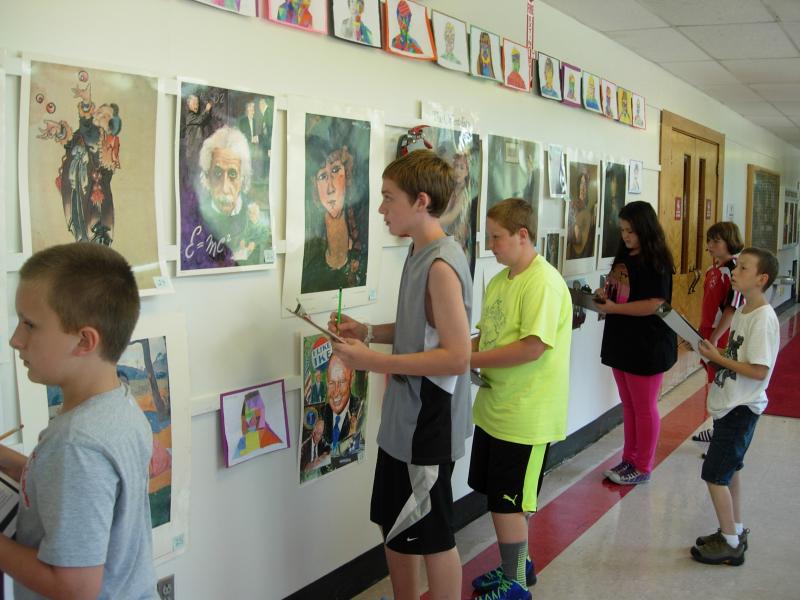 Wiscasset Middle School students study various portraits during art class. Courtesy of Cynthia Collamore